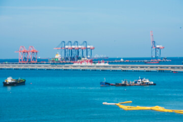 Fototapeta premium Logistic shipping quay boat Engineering crane depot at logistic export terminal control. Warehouse freight background container yard loading quayside harbor port. Logistics seascape shipping portal