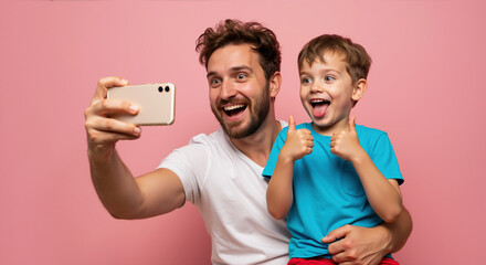 Excited father and son taking selfie with smartphone making thumbs up on pink background. Father's day bonding activities and family fun moments