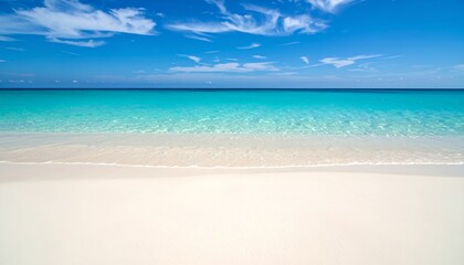 Turquoise Ocean Meets White Sand Beach Under Blue Sky