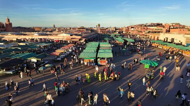 Marrakesh, Morocco: Panoramic footage of people enjoy a late afternoon on the famous Jemaa el-Fnaa square in Marrakesh old town Medina in Morocco. 