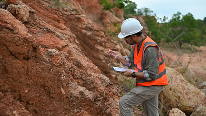 Geologists analyze the soil in their hands and record it