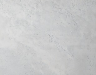 A plain light-colored textured wall with subtle cracks and rough plaster surface.