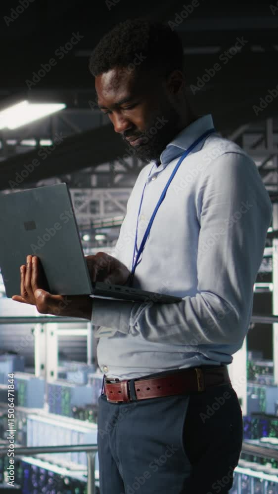 Poster vertical video engineers in data center using laptop to monitor neural network llm visualization. co