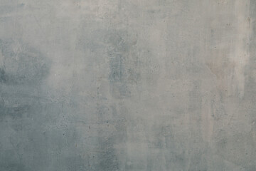 Art background of shabby grey plastered wall with a blue tint and gradient, copy space.