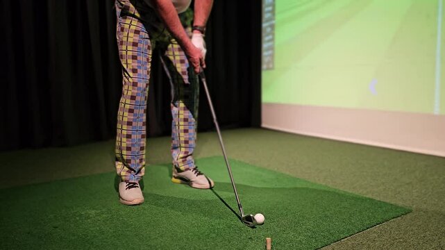Golf practice session at indoor facility with simulated course on display - Powered by Adobe