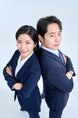 Confident Asian Businessman and Businesswoman Standing Back to Back with Arms Crossed in Suits, Teamwork Concept