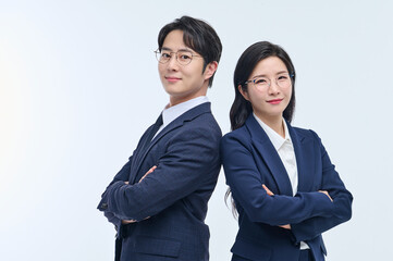 Confident Asian Businessman and Businesswoman Standing Back to Back in Formal Suits, Gesturing Ideas and Vision on White Background
