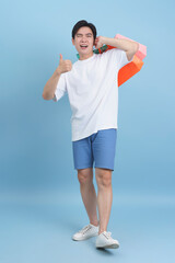 Young man shopping with colorful bags in a cheerful atmosphere during a sunny day
