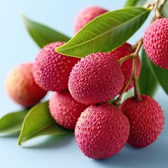 Fresh lychee fruit branch on blue background, lychee cluster with green leaves and vibrant lychee texture