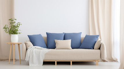 A white sofa with blue cushions against a light empty wall