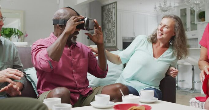 Animation of happy diverse female and male senior friends using vr headset and having fun