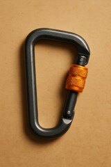 Rock Climbing Carabiner: A close-up shot of a carabiner, essential safety gear in rock climbing, with a sturdy metal construction. The orange locking mechanism stands out against the dark carabiner.