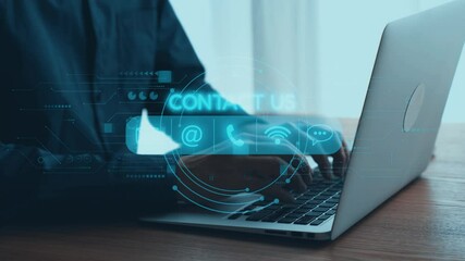 A professional individual uses a laptop in a modern office environment. Digital contact icons overlay the scene, highlighting virtual communication and connectivity options. Qubit - Powered by Adobe