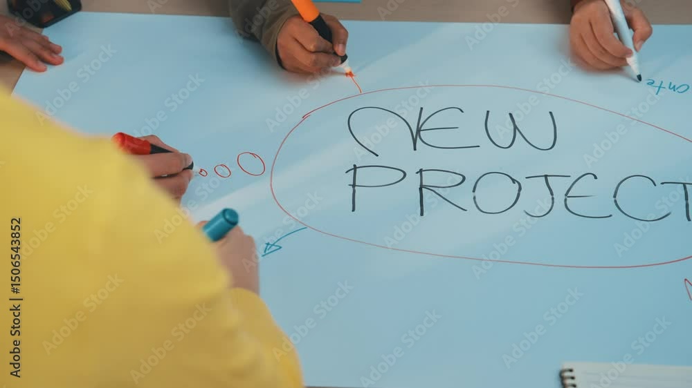 Poster person engaged in writing new project ideas on a sticky note in a colorful workspace. this image cap