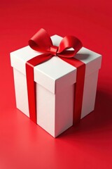 Fototapeta premium Red ribbon tied bow atop white polka dot box on red line , design, stripe