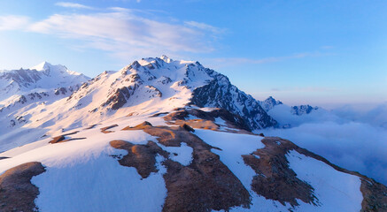 drone image of Snow-covered Sar Pass summit