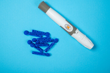 Lancet and a disposal syringe for checking blood sugar level. Concept of diabetes or a healthy lifestyle
