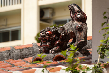 Traditional 'Ryukyuan' 'Shisa' or guardian dog on a rooftop on Tsuboya Street in Naha, the capital of Okinawa.  Tsuboya Street is the centre of Okinawan pottery.