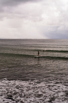 Surfers catch waves, Noosa Heads, T-Tree Point