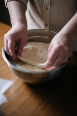 A man checks if the yeast dough is ready