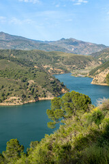 Fototapeta premium Rules Reservoir on the Guadalfeo River is a vital water body nestled among striking mountainous terrain, offering picturesque views and regional significance in Granada, Spain