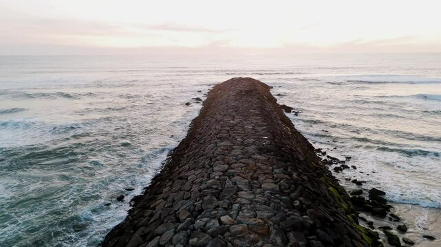 rock stone deck extends into ocean at s&atilde;o pedro de maceda beach in ovar portugal