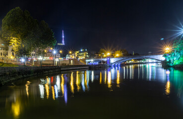 Night view of the Kura (Mtkvari) river with reflections of lantern light. Metekhi Bridge,...
