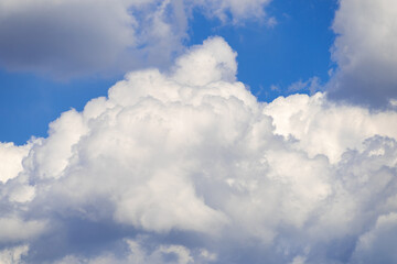 Fluffy white clouds against a bright blue sky