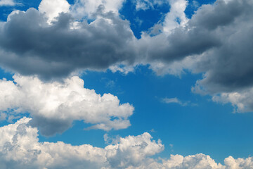 Dramatic cloudscape with blue sky and vibrant white clouds © bykot