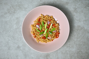 Spicy fried Indomie with spring onion sprinkles ready to serve