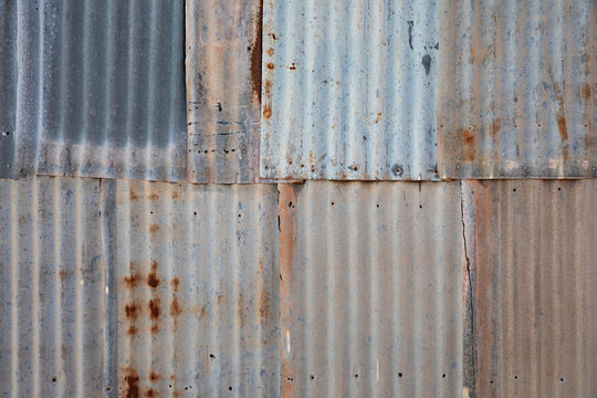 Pattern of weathered and rusty corrugated tin sheets - surface background