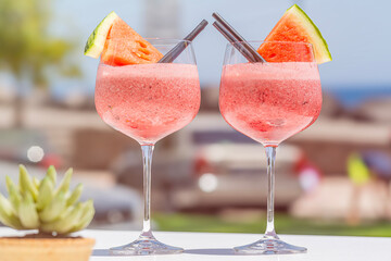 refreshing watermelon smoothie on a hot day at the beach on vacation concept