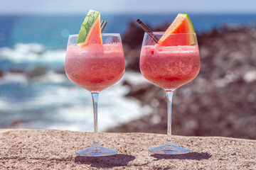 refreshing watermelon smoothie on a hot day at the beach on vacation concept