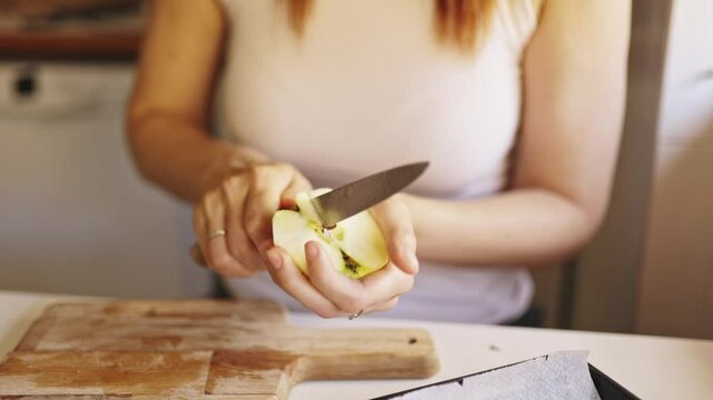 Pastry chef removing apple core in kitchen