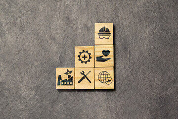 Wooden cubes with an HSE sign on a black background. Abbreviation of Health, Safety, and...