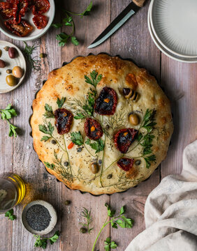 Top view baked focaccia bread decorated with flower design.