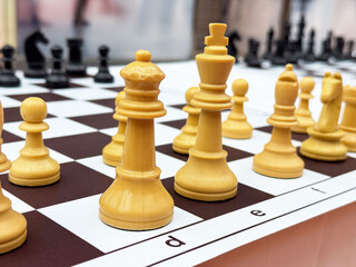 Dynamic chess game in progress with cream-colored pieces on board