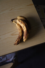 Top Down Shot of Three Ripe Bananas on a Rustic Table.
