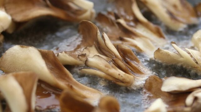 Hen of the Woods or Maitake Mushroom are Fried in Boiling Oil. Close up View