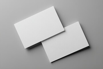 Two blank business cards laid atop a neutral background