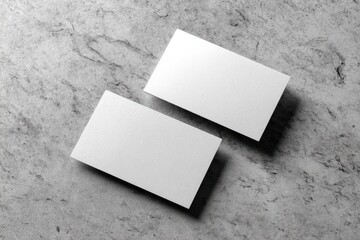 Blank business cards on a stone surface