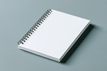 Blank spiral-bound notebook on a gray surface