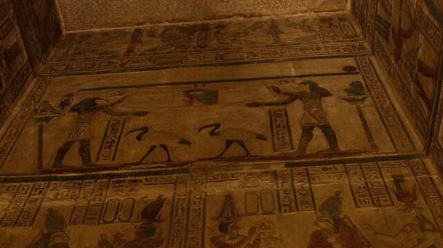 Ancient Egyptian gods on wall painting inside the Temple of Dendera, Egypt