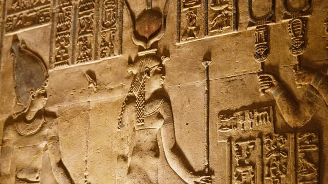 Ancient Egyptian wall carving with goddess and hieroglyphs, Dendera temple, Egypt