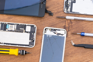 Gadget repair tools next to faulty displays, top view