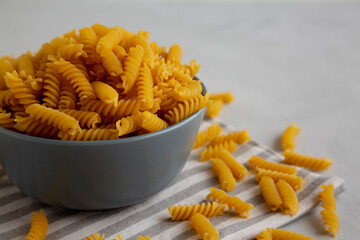 Dry Fusilli Pasta in a Bowl, low angle view. Copy space.