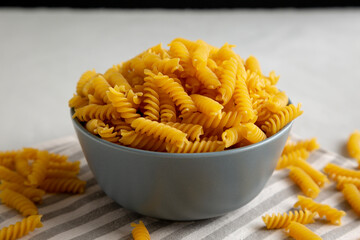 Dry Fusilli Pasta in a Bowl, low angle view. Close-up.
