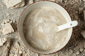 Activation of wet fresh yeast in warm water with sugar.