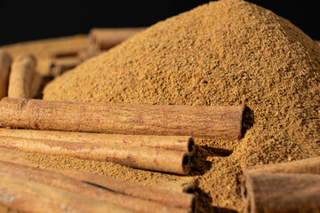 Close-Up of Brown Ground Spice and Cinnamon Sticks. Natural Food Scene.
