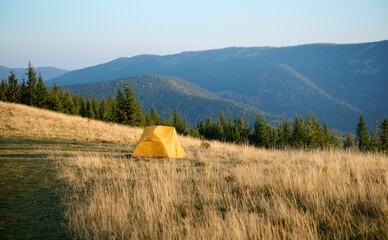Tent in the mountains. Camping concept. Perfect for holiday leisure, outdoor activities, and a...